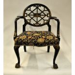 A black lacquered and polychrome decorated Chinese Chippendale style elbow chair with Morris style