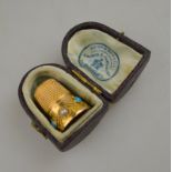 A 15ct gold thimble with cannetille work decoration, set with turquoise and pearls, in fitted case,