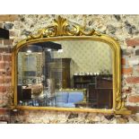 A Victorian giltwood and plaster arched frame overmantel, raised on porcelain feet,