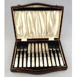 A set of Edwardian dessert knives and forks with engraved silver blades,