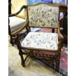 A continental carved and moulded frames open armchair with tapestry style upholstered seat and back