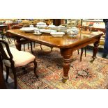 A substantial mid 19th century mahogany extending dining table with four even leaf inserts, raised