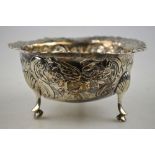 An 18th century Irish sugar basin with engraved and shaped rim and embossed and chased sides