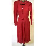 A 1970's Jean Muir, London raspberry viscose jersey day dress with grey/blue/black motif and four