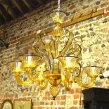 A Venetian blue edged amber glass chandelier by Murano having scroll arms, 73 cm diameter x