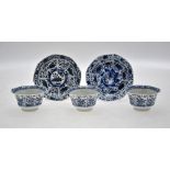 Three 18th century Chinese blue and white tea bowls and two matching saucers decorated with panels