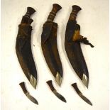 Three military style kukris with wood-mounted hilts and leather scabbards - all a/f