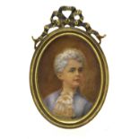 An oval portrait miniature of a boy in 18th century costume,