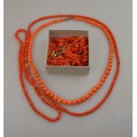 Two rows of coral beads, box of loose stick coral, silver and enamelled locket, two stick pins - one