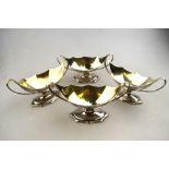 A set of four George III Adam design open salts of navette and fan form, with twin handles and