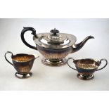 A heavy quality silver three-piece tea service of oval half-reeded form, E H Parkin & Co. Ltd.