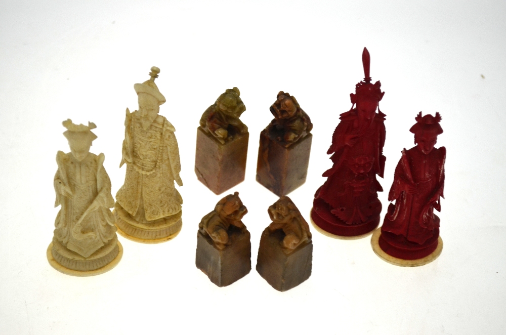 A set of four Chinese ivory chess pieces, kings and queens, one pair stained red,