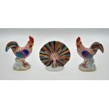A pair of Herend porcelain cockerels, 23.5 cm high and a peacock, 11 cm high (3) Condition Report