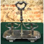 A William IV silver double bottle-stand with embossed loop handle,