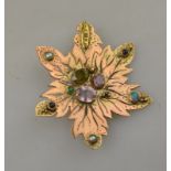 A gilt metal pierced leaf brooch set with multi-coloured stones including amethyst,