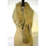 A dark brown deep fox fur stole, two other fox furs with heads and feet,