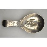 A George III silver caddy spoon, the sifter bowl with filigree grill within engraved floral and