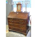 An 18th century mahogany bureau with fitted interior over four long graduated drawers,