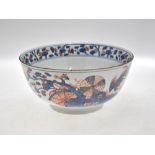 A Chinese early 18th century Imari bowl decorated with fabulous birds amidst prunus, 31.5 cm diam.