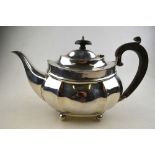 An oval silver teapot with beaded rim and ogee body, on ball feet, Thomas Edward Atkins,