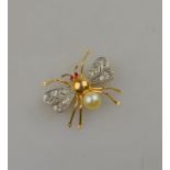 A yellow and white metal flying insect brooch having eight cut diamond set wings,