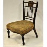 A Victorian inlaid rosewood nursing chair with overstuffed tapestry seat