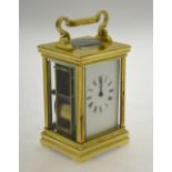 A French lacquered brass two cylinder 8-day carriage clock with folding handle striking the half