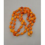 A single row of pressed amber beads knotted throughout, approx 1.5oz Condition Report Beads