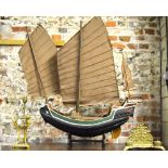 A large Chinese painted wood model of a sailing boat in sail,