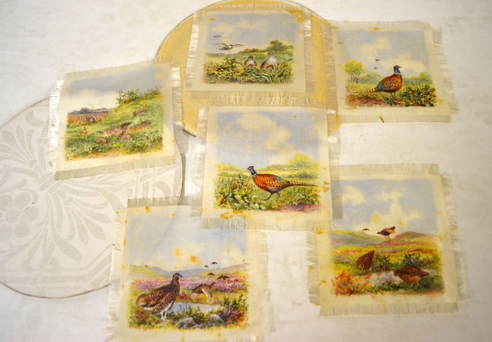 A box of table linen to include a hand-painted set of table mats,