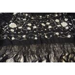 A Chinese black silk shawl with overall ivory silk embroidered floral sprays,