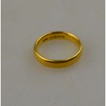 A 22ct yellow gold court style wedding band, at present size L, approx 5.