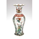 A Chinese Famille vert octagonal section slim vase with waisted neck having two large panels, one