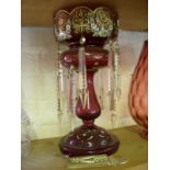 Victorian ruby glass lustre with enamel decoration and crystal droppers.