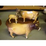 Beswick bull ‘Ch. Brinsley Coy Boy’, and Jersey cow and calf on plinth. (2)