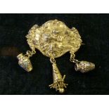 Silver gilt cherub brooch with three hanging pendants.