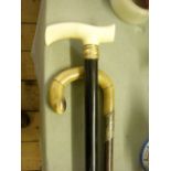 Silver-mounted horn walking stick; ivory handle walking stick.