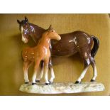 Beswick bay mare with foal, on china base