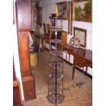 Victorian cast iron eight-tier pan stand, manufactured by A. Kenrick & Sons. Star-pattern tiers, paw