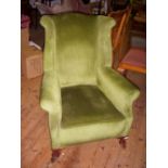 Edwardian armchair with green-upholstery and mahogany cabriole foot.