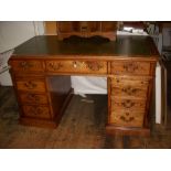 Georgian manner oak kneehole desk, leatherinsert top above central drawer flanked by four drawers