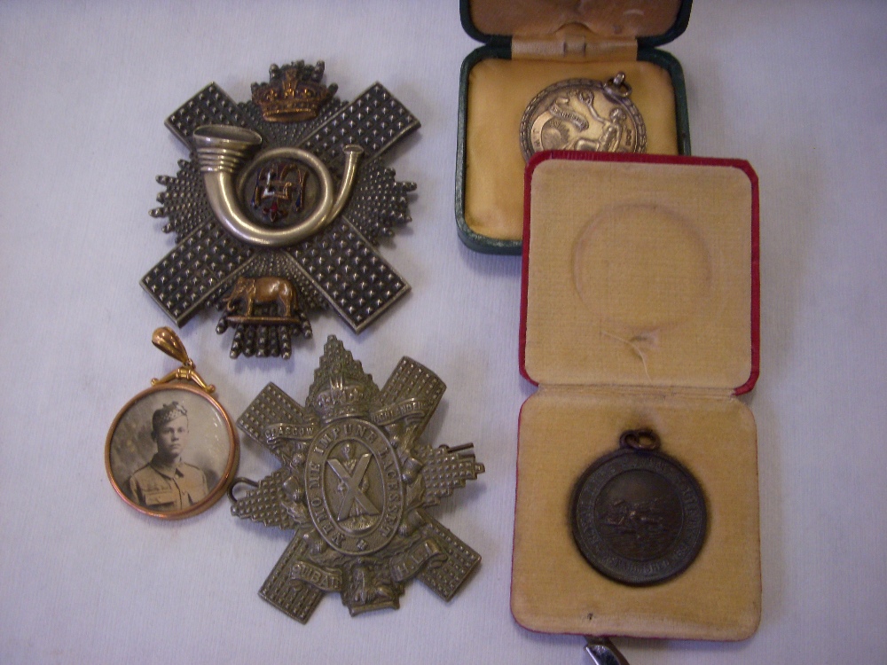 Gold mounted photograph pendant; Highlanders Light Infantry badges; life-saving medallions.(5)
