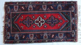 A blue ground rug, the central panel wit
