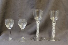 A pair of 18th century cordial glasses with double helix cotton twist stems on a spreading foot,