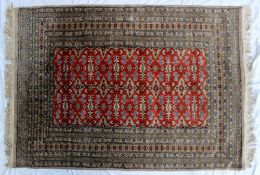 A red ground rug with a central panel de