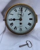 A brass bulk head timepiece, the circular dial with a seconds subsidiary dial inscribed Smiths