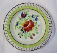A Swansea pottery ribbon plate painted to the centre with a spray of garden flowers, 21.5cm