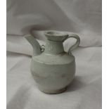 A 19th century Chinese porcelain white glazed jug with a tapering neck, ribbed body and spreading