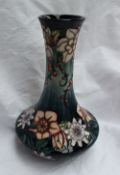 A modern Moorcroft carousel pattern vase with a tapering neck and squat body, impressed mark, signed