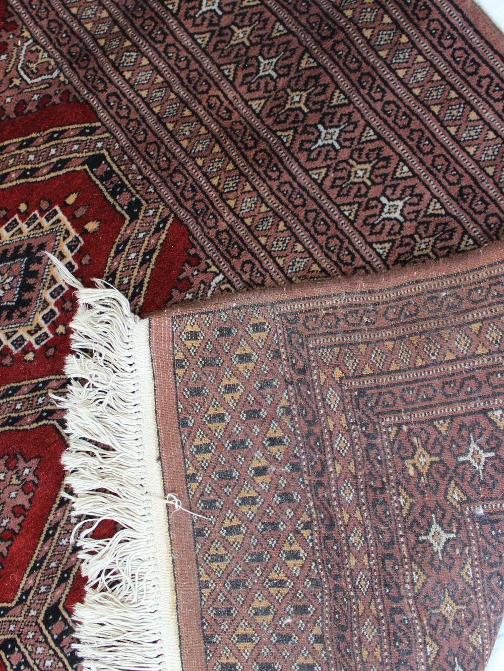 A red ground rug with a central geometri - Image 5 of 6